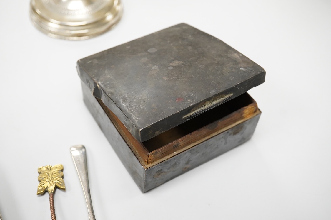 A collection of silver and white metal items, to include a cigarette box, a/f, a German dwarf candlestick, a cased spoon and pusher, etc.